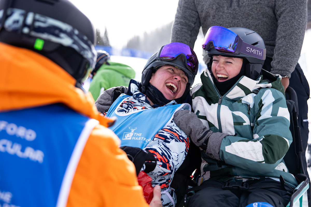 Ski Spec attendees hugging and laughing together