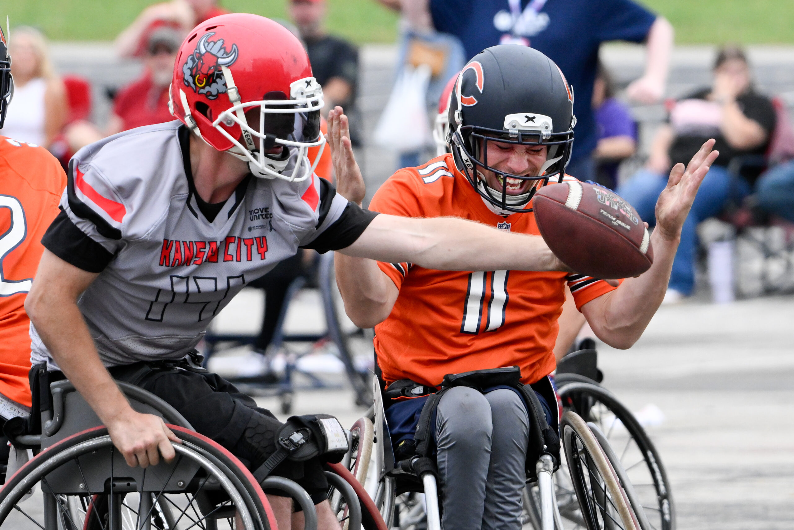 Kansas City Smoke athlete breaking up a pass in a wheelchair football game.
