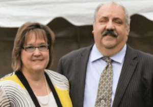 Deb and Ralph Armento looking at camera