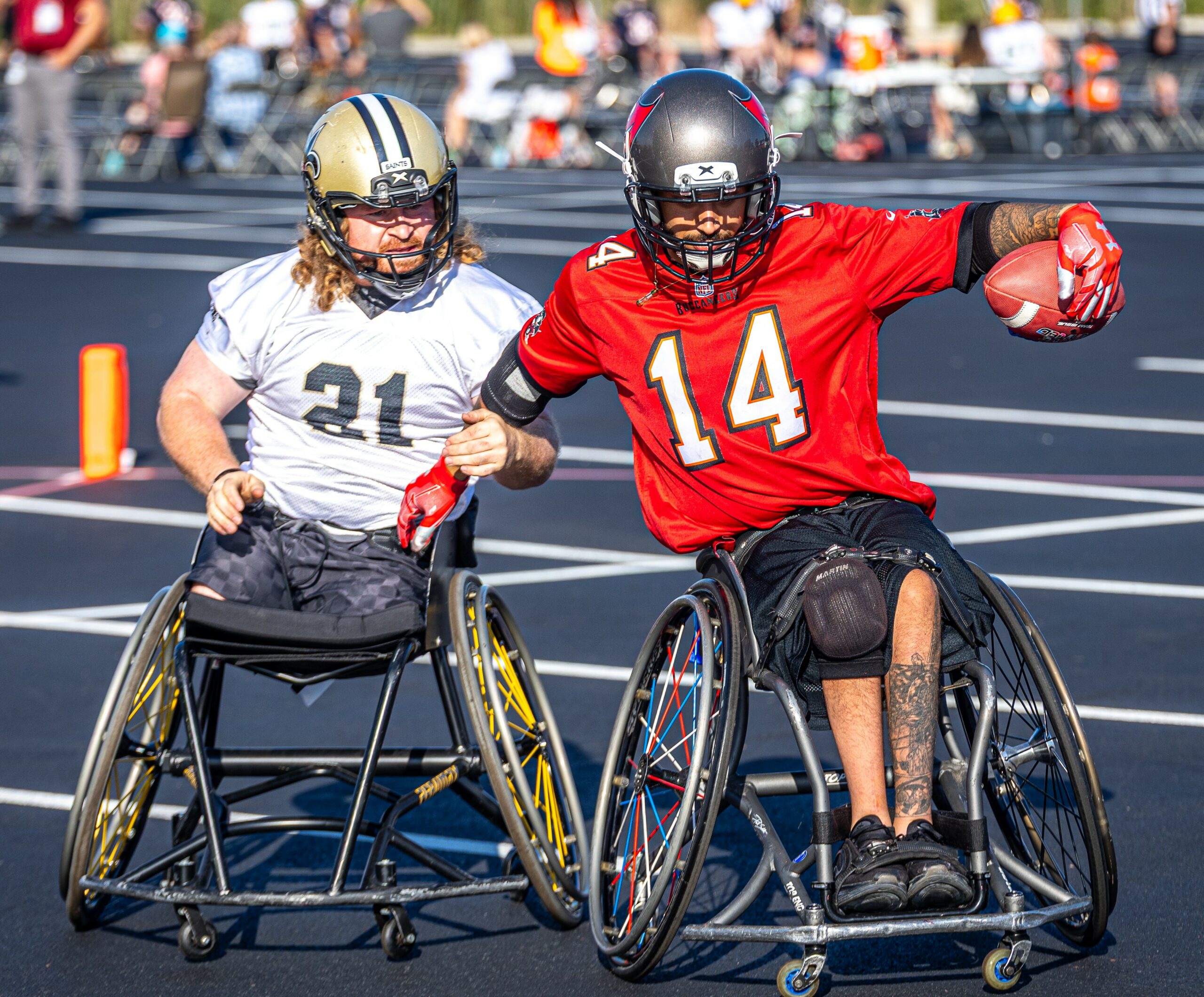 USAWFL Saints and Buccaneers athletes going down field