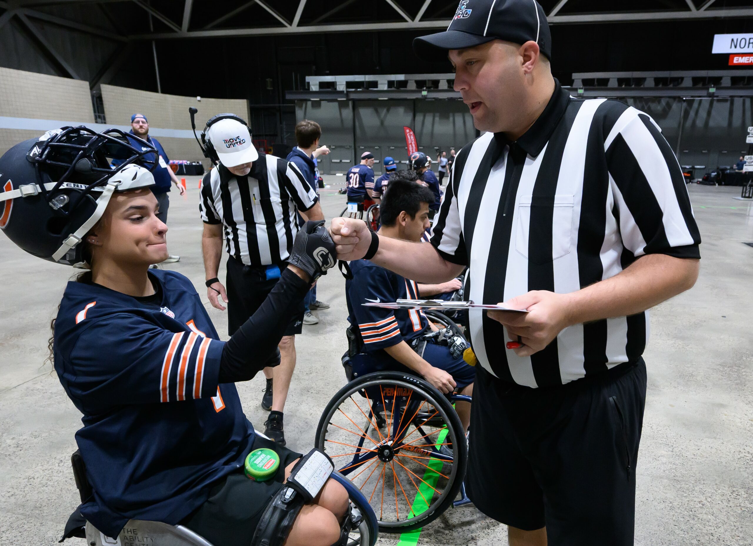 USAWFL Officials fist bumping an athlete while completing chair checks