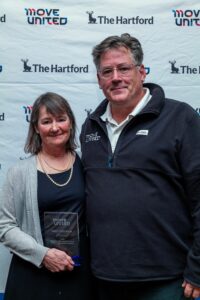 Nancy Gustafson accepts award from Glenn Merry