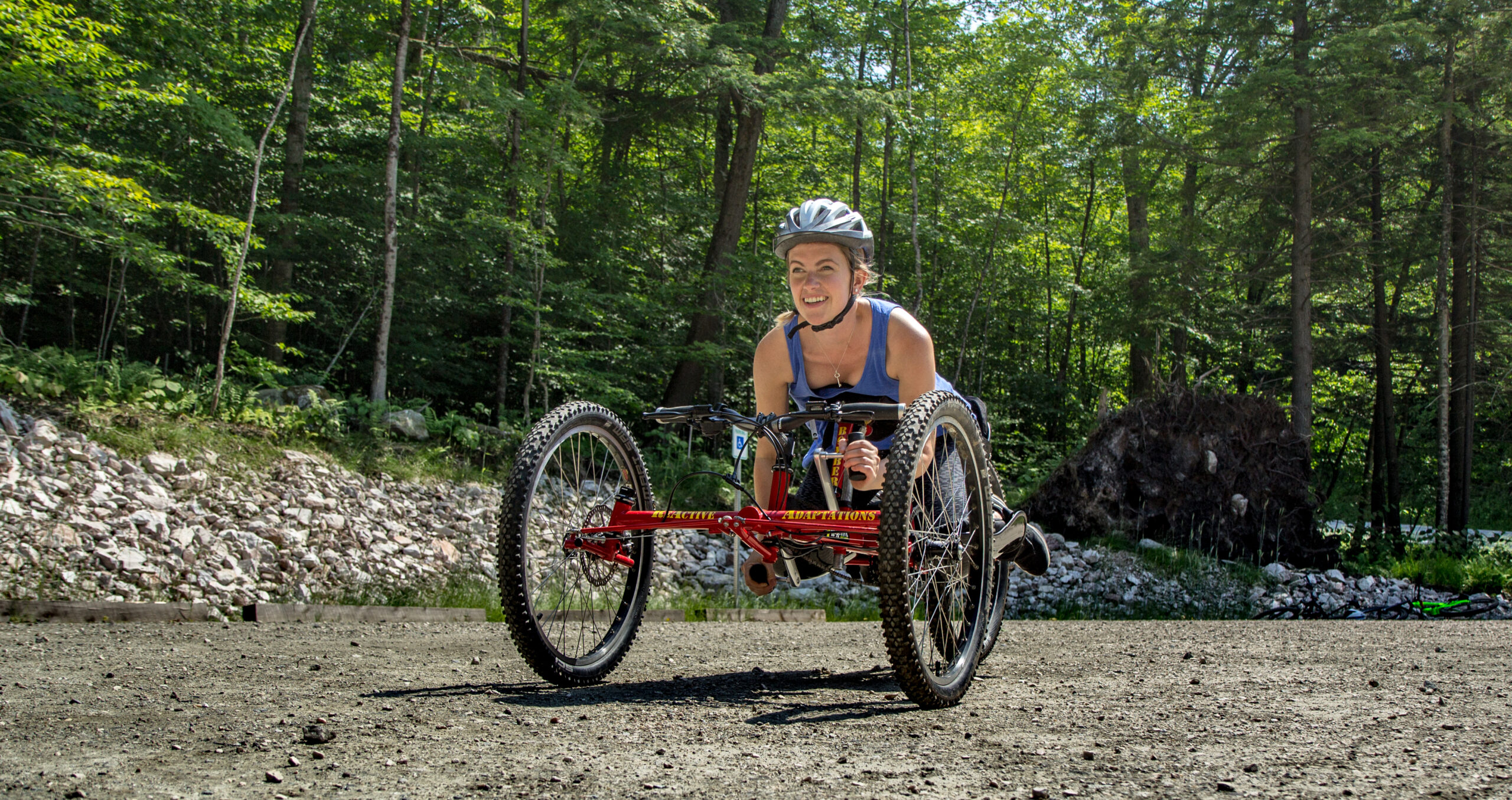Female using an adaptive mountain bike on a trail
