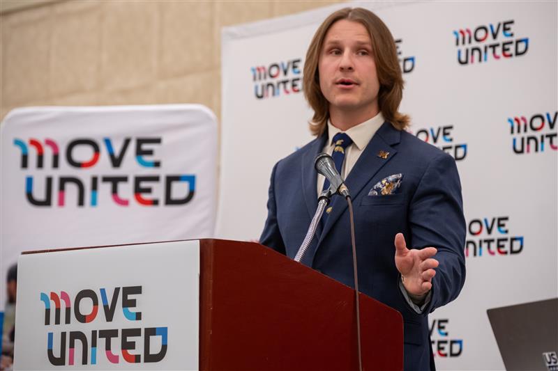 Erik speaks from a podium at the 2026 Move United Education Conference.