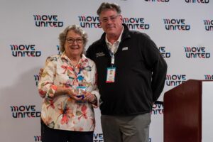 Barb Peacock accepts Jim Winthers Award from Glenn Merry