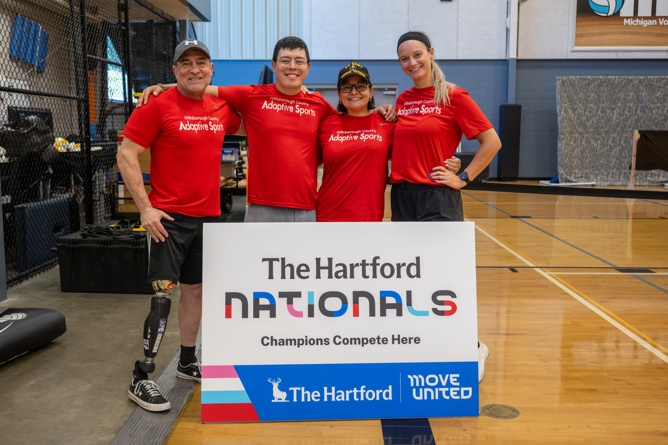 Hillsborough County Florida team members standing behind The Hartford Nationals sign