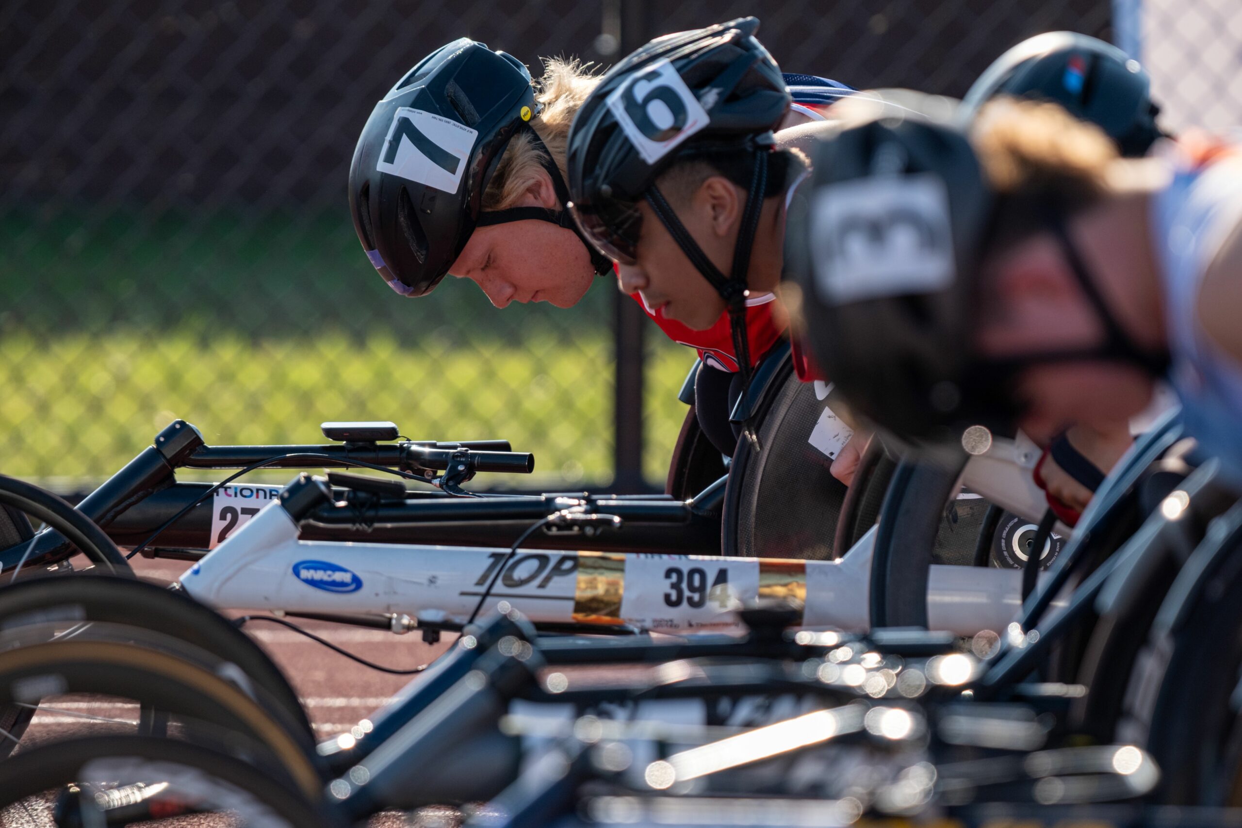 Wheelchair racers lined up at the start line focused on the race ahead