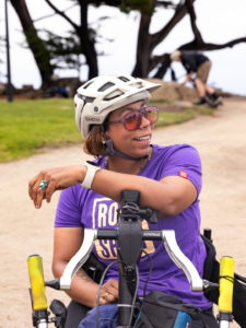 Annijke Wade riding an adaptive bike and posing with a smile