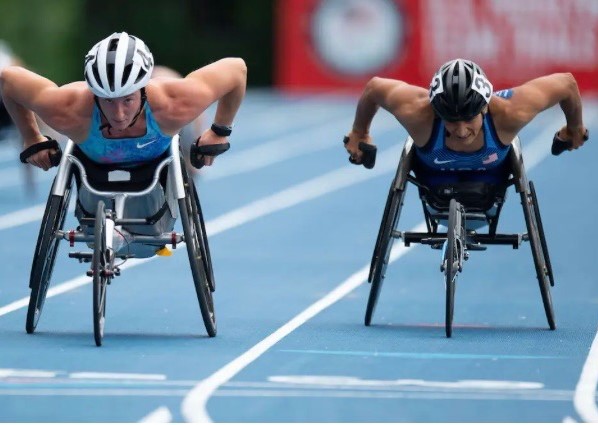 Cheri competes against an opponent during a wheelchair track race