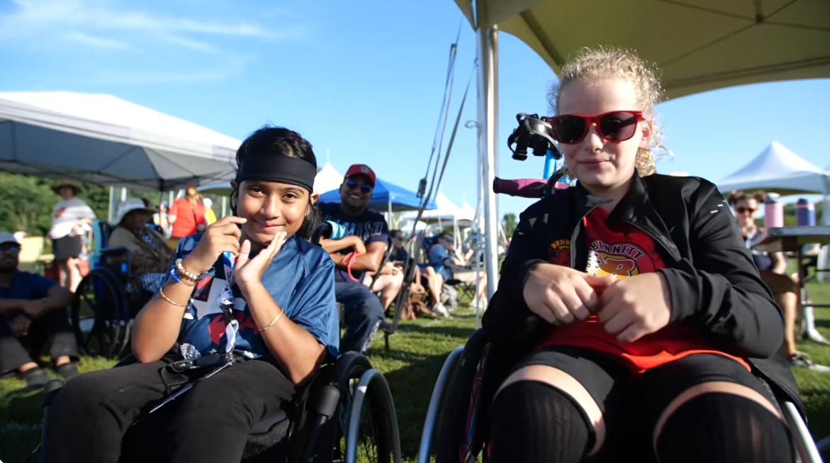 Two young athletes sitting in their everyday wheelchairs