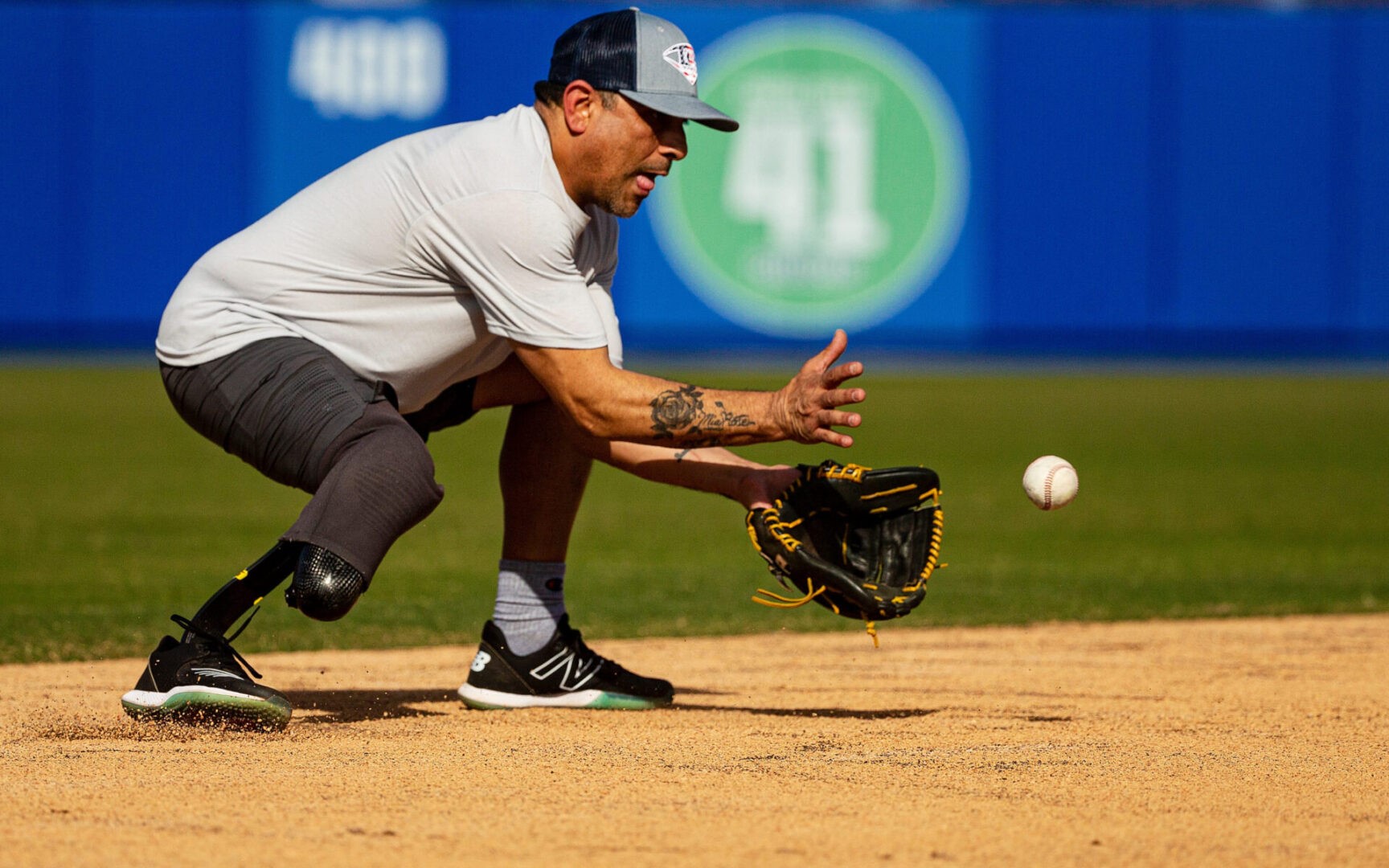 Baseball player with right leg amputation getting ready to field the ball
